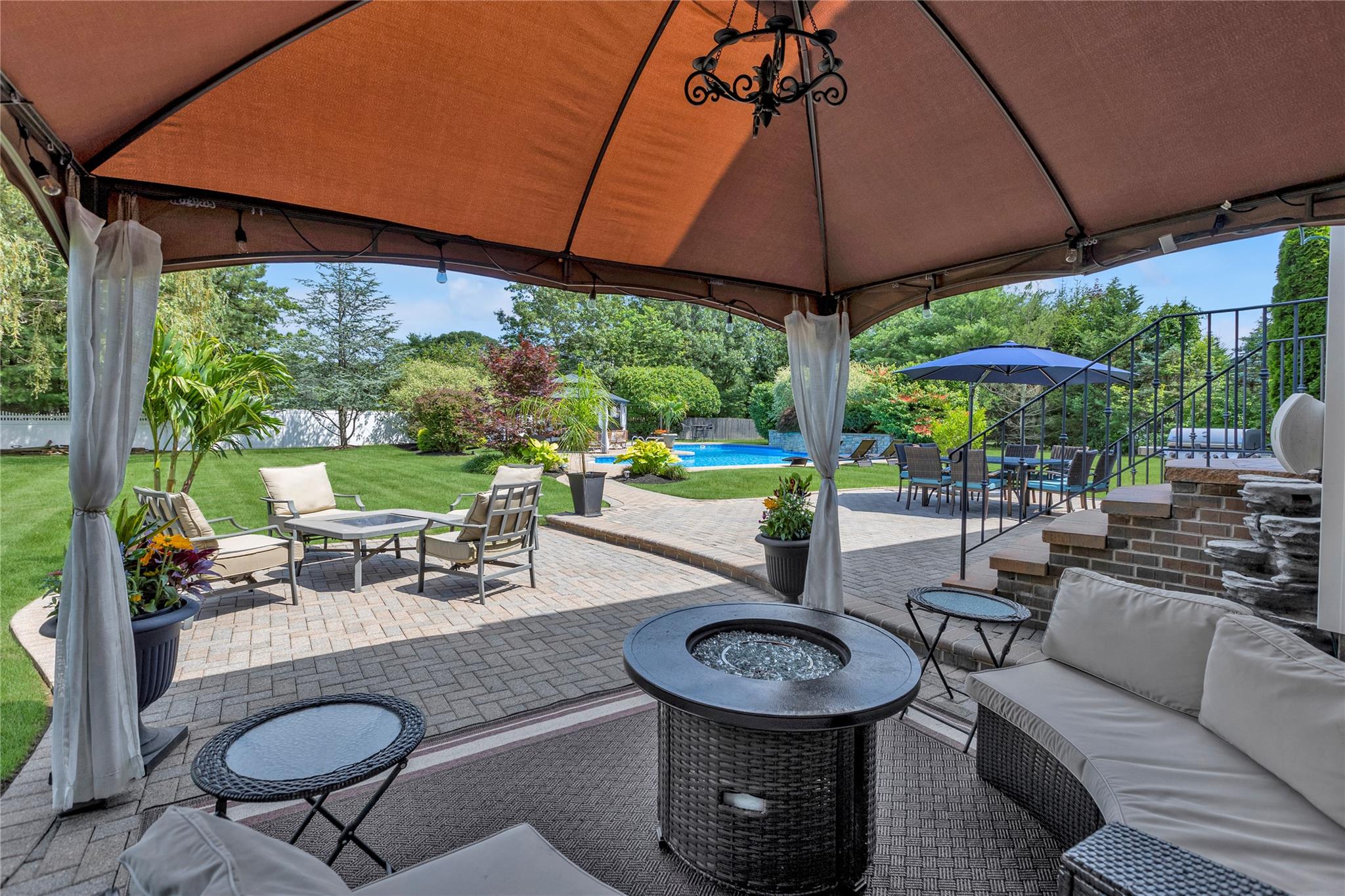 265 Hidden Acres Path Wading River, NY 11792 - Photo 36 of 46 Fenced backyard with a gazebo, an outdoor living space with a fire pit, a patio, and an outdoor pool