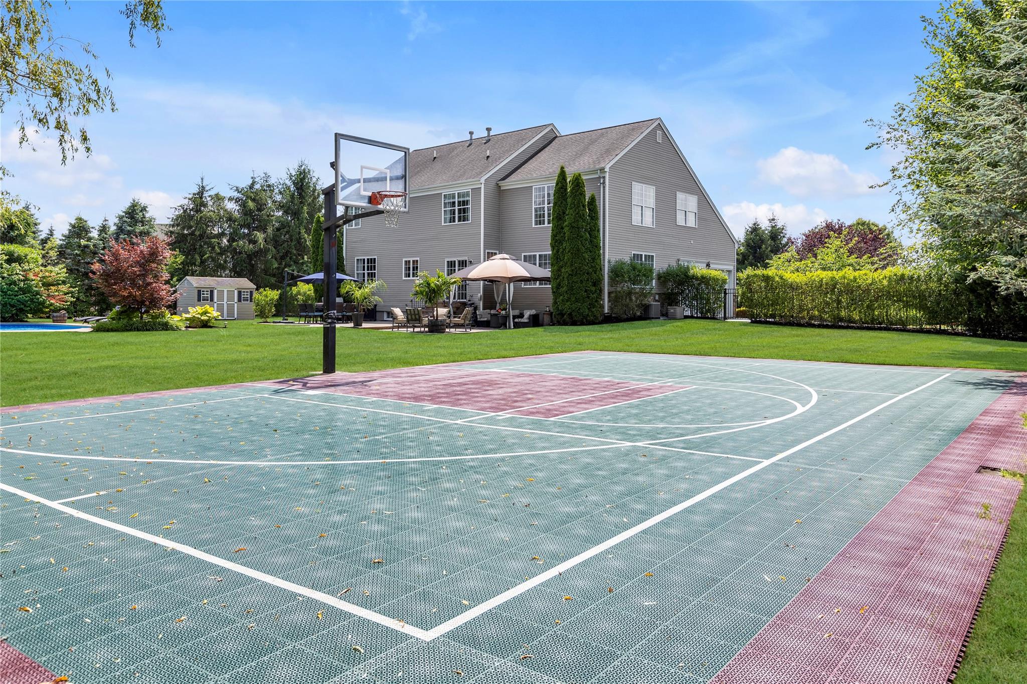 265 Hidden Acres Path Wading River, NY 11792 - Photo 37 of 46 View of basketball court featuring basketball hoop, a gazebo, and a lawn