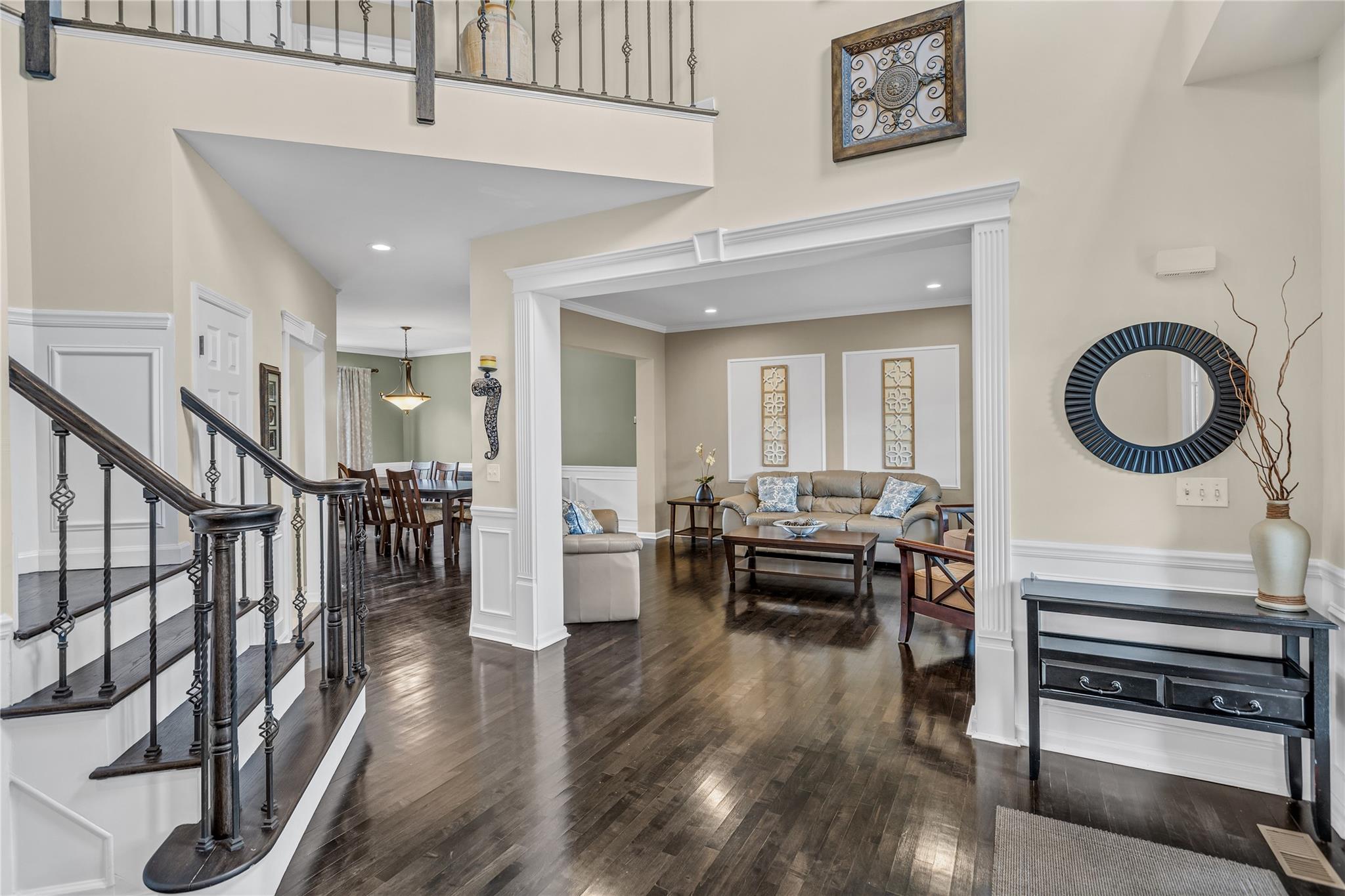 265 Hidden Acres Path Wading River, NY 11792 - Photo 6 of 46 Entryway with wood finished floors, a wainscoted wall, a decorative wall, stairs, and a high ceiling