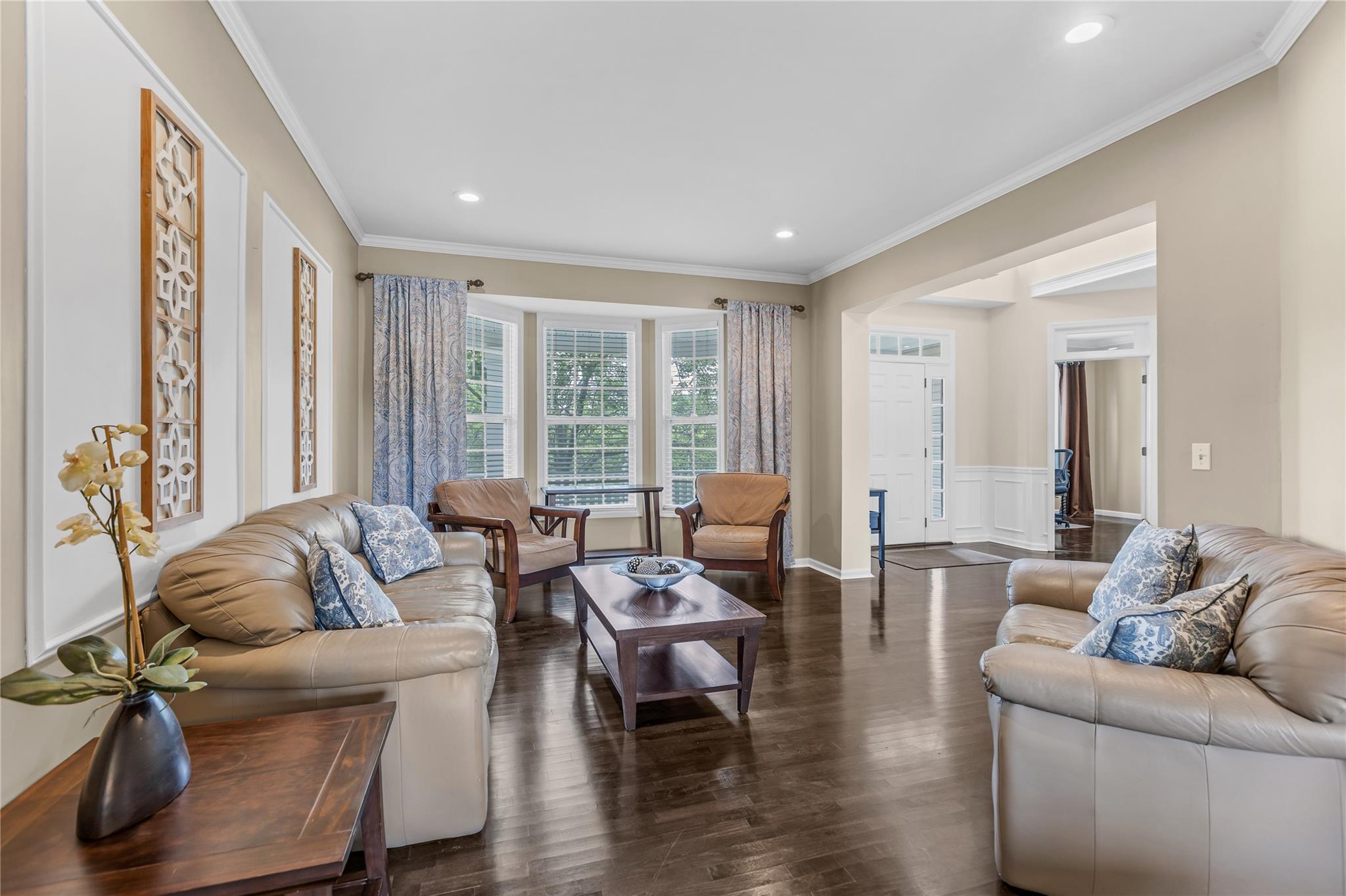 265 Hidden Acres Path Wading River, NY 11792 - Photo 7 of 46 Living area featuring ornamental molding, dark wood-type flooring, a wainscoted wall, recessed lighting, and a decorative wall