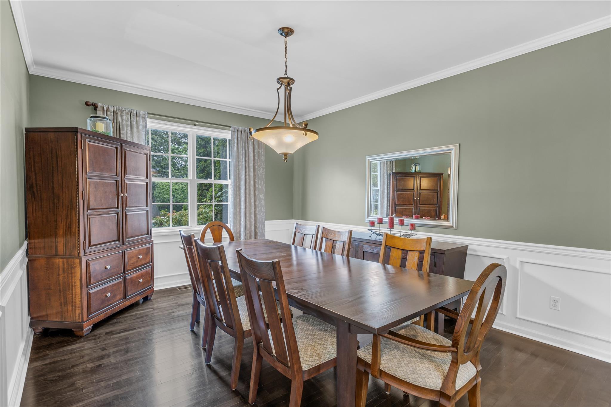 265 Hidden Acres Path Wading River, NY 11792 - Photo 8 of 46 Dining space with ornamental molding, dark wood finished floors, a decorative wall, and wainscoting