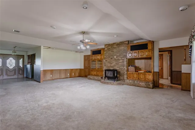 an empty room with furniture and a fireplace