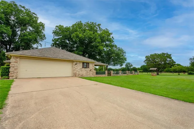 a view of backyard of house with green space