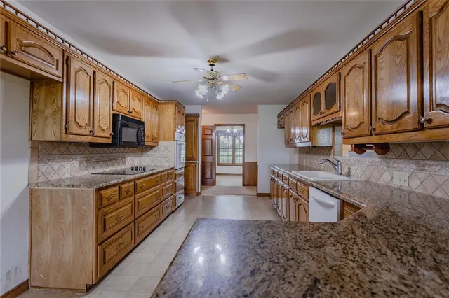 a kitchen with stainless steel appliances granite countertop a stove cabinets and microwave