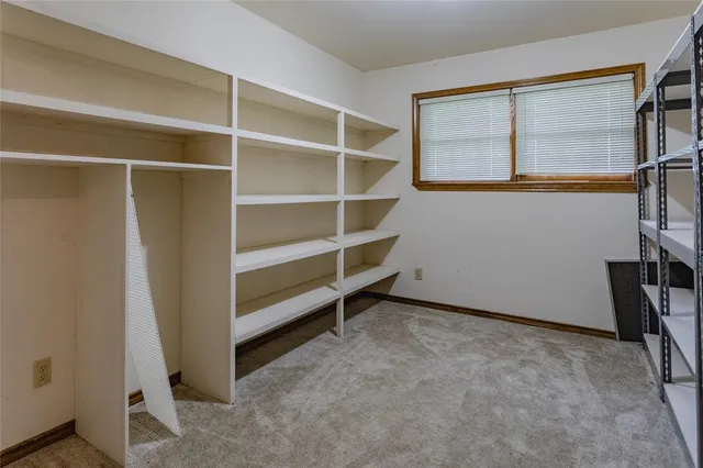 a view of an empty room with a closet