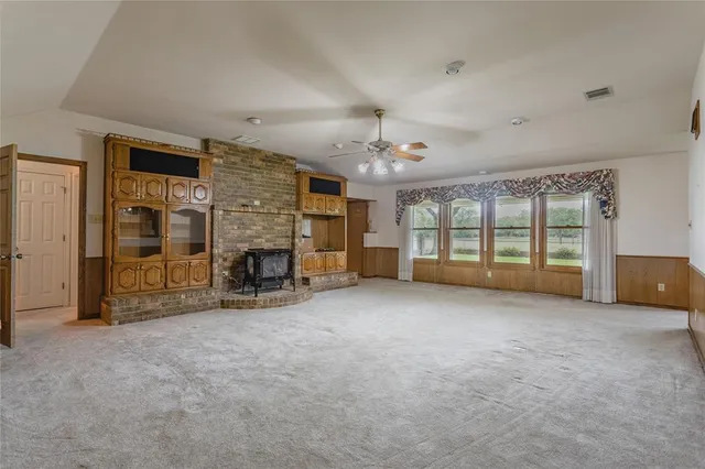 an empty room with furniture and a fireplace