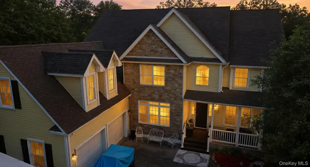 a front view of house along with deck and outdoor seating
