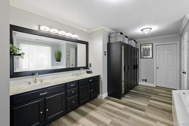 a bathroom with a double vanity sink and mirror