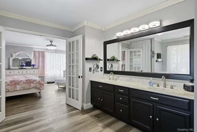a spacious bathroom with a double vanity sink and a mirror