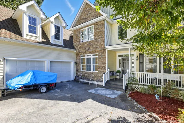 a view of a house with a yard porch and furniture