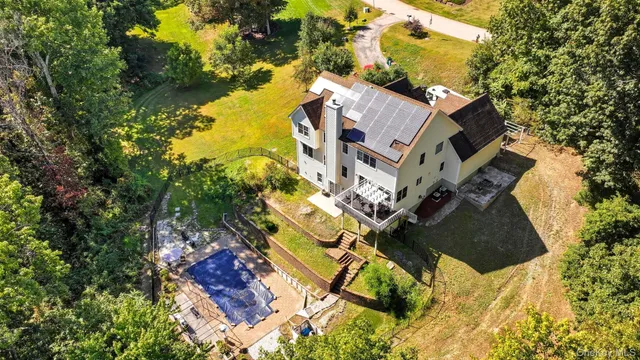 a aerial view of a house with a yard