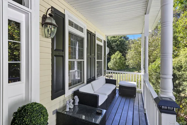 a balcony with furniture and wooden floor