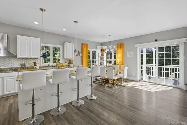 a large white kitchen with lots of counter space and windows