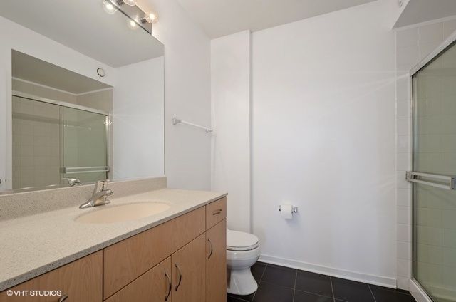 a bathroom with a sink a toilet a shower and a mirror