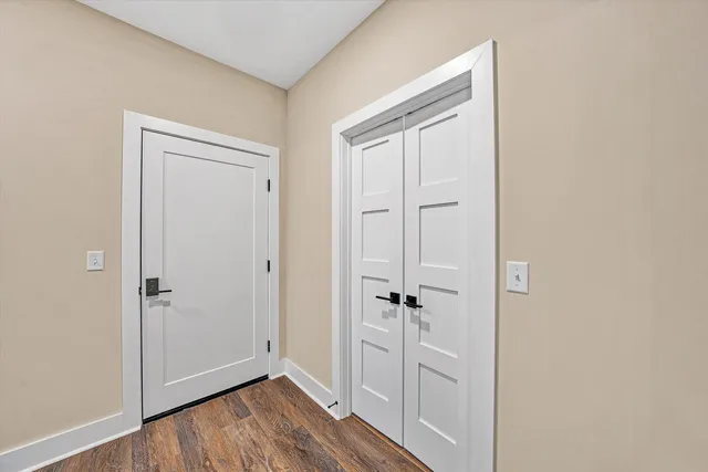 a view of a hallway with wooden floor