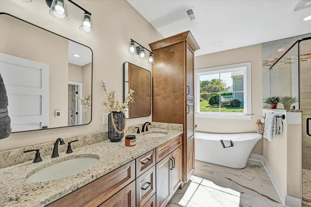 a bathroom with a double vanity sink mirror and toilet