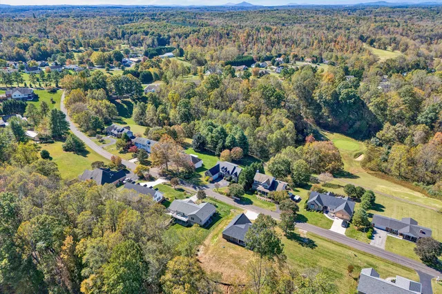 an aerial view of a house with garden space and street view