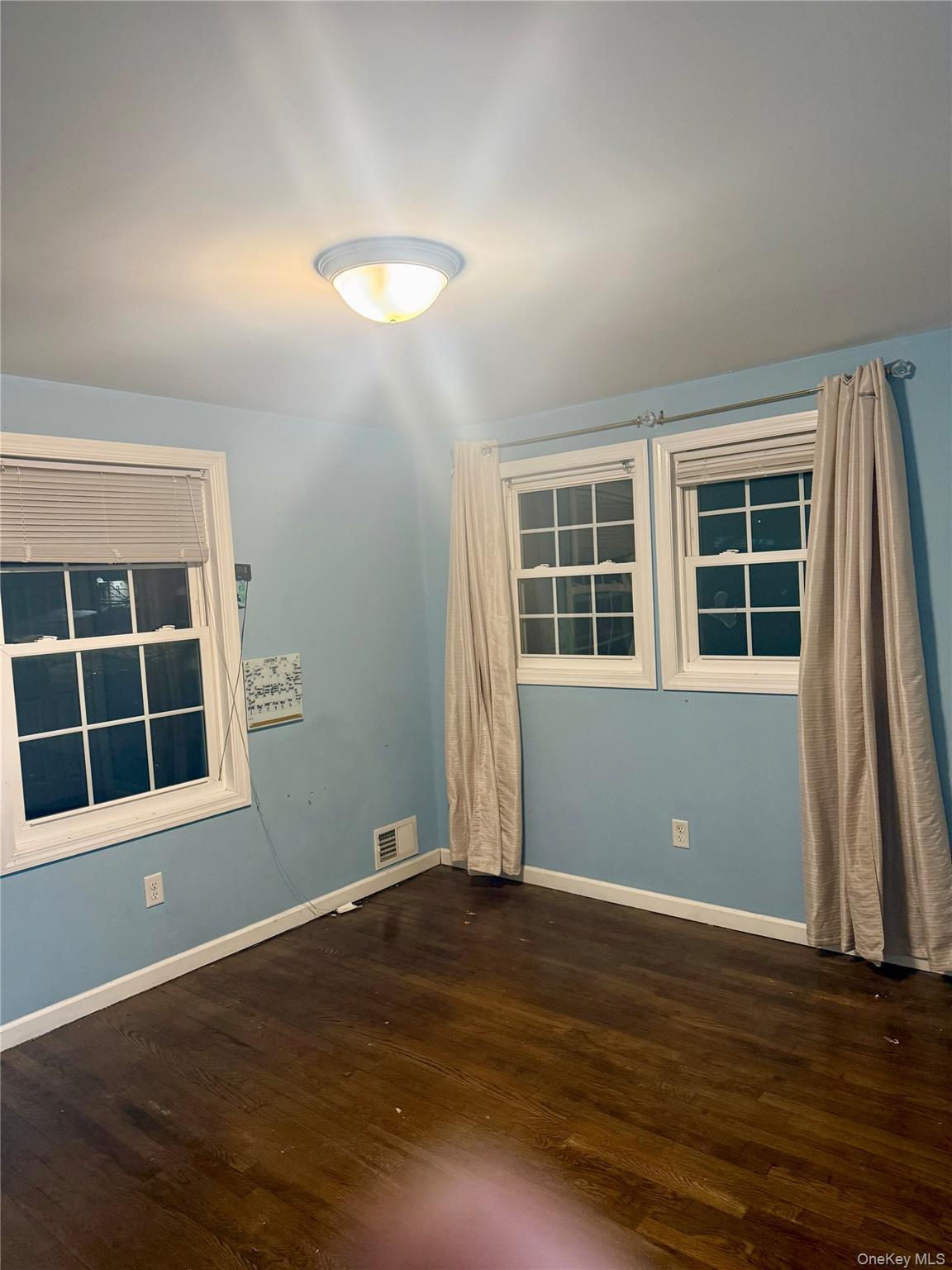 47 College Road Selden, NY 11784 - Photo 9 of 15 Spare room with dark wood finished floors