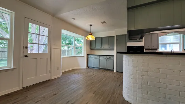 a view of a kitchen with a sink and dishwasher wooden floor