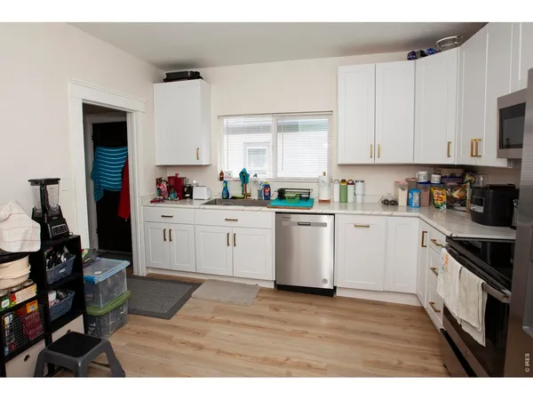 a kitchen with sink cabinets and window