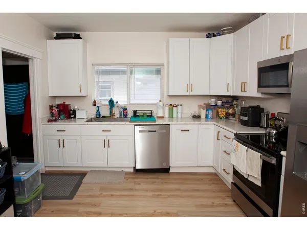 a kitchen with cabinets stainless steel appliances a sink and a counter top space