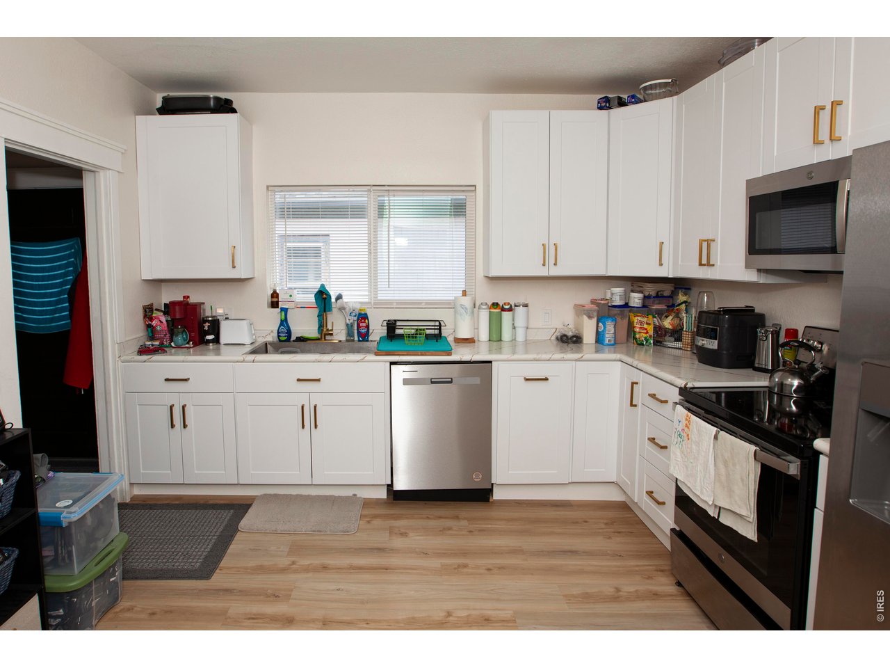 212 Denver Street Sterling, CO 80751 - Photo 12 of 30 a kitchen with cabinets stainless steel appliances a sink and a counter top space
