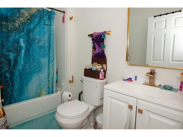 a bathroom with a sink vanity mirror and toilet
