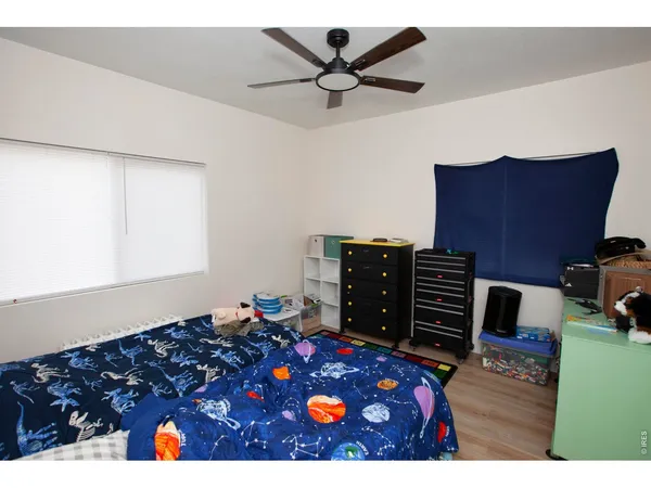 a bed room with a bed window and television