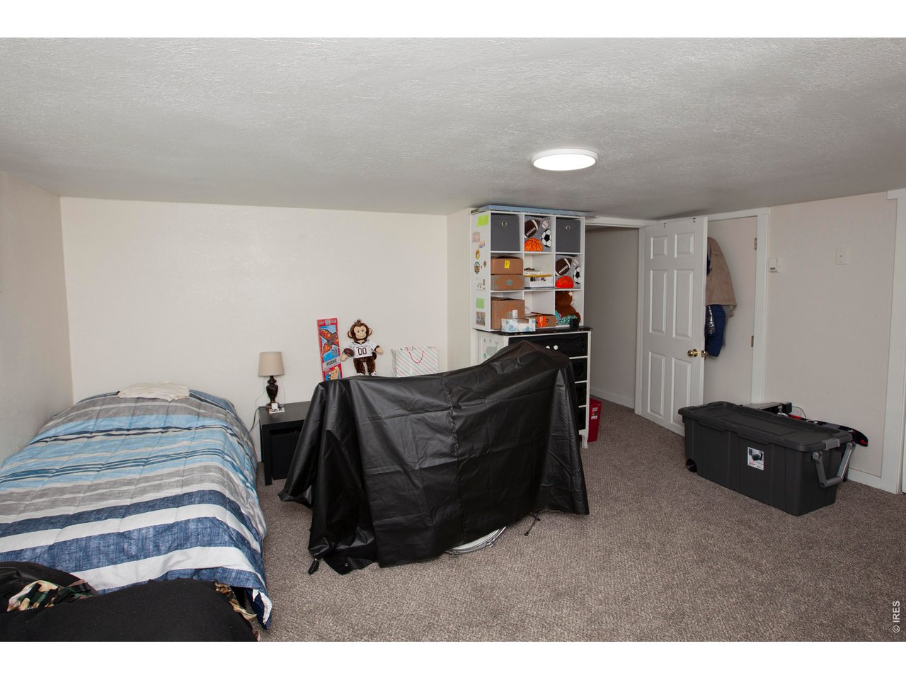 212 Denver Street Sterling, CO 80751 - Photo 22 of 30 a bedroom with a bed and dresser
