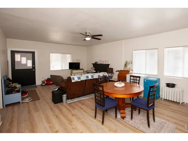 a living room with furniture a wooden floor and a window
