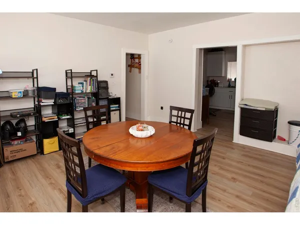 a dining room with furniture and wooden floor