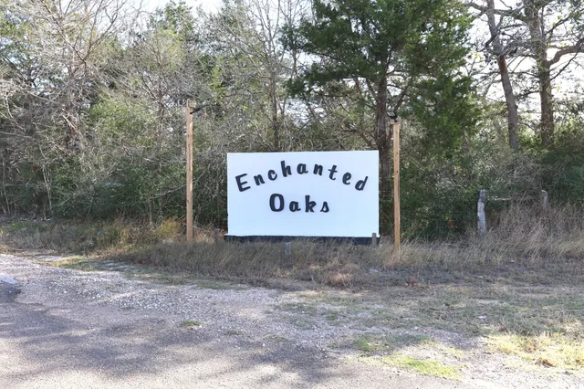 a sign of golf club on a stone wall