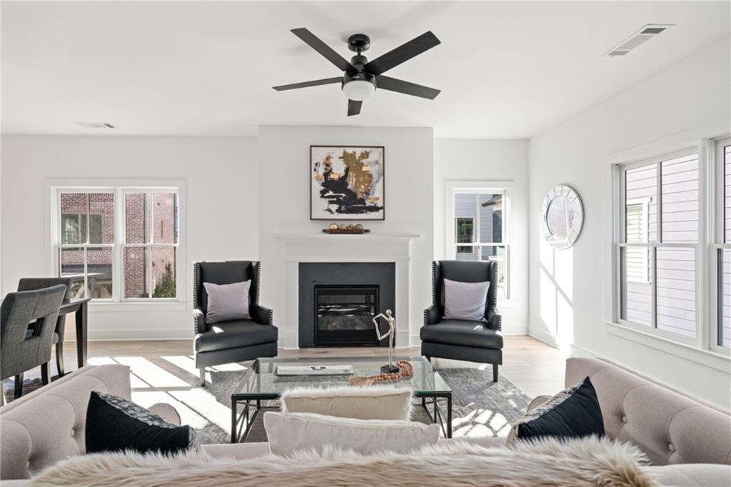 3312 Springhaven Avenue Hapeville, GA 30354 - Photo 13 of 54 a living room with furniture a fireplace and large windows