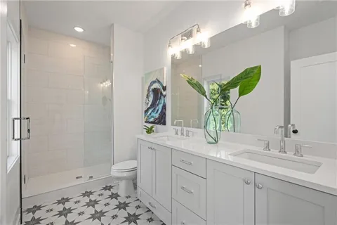 a bathroom with a toilet and a shower