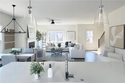 a living room with furniture and a chandelier