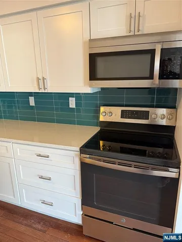 a stove top oven sitting inside of a kitchen