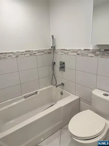 a bathroom with a toilet and a bathtub