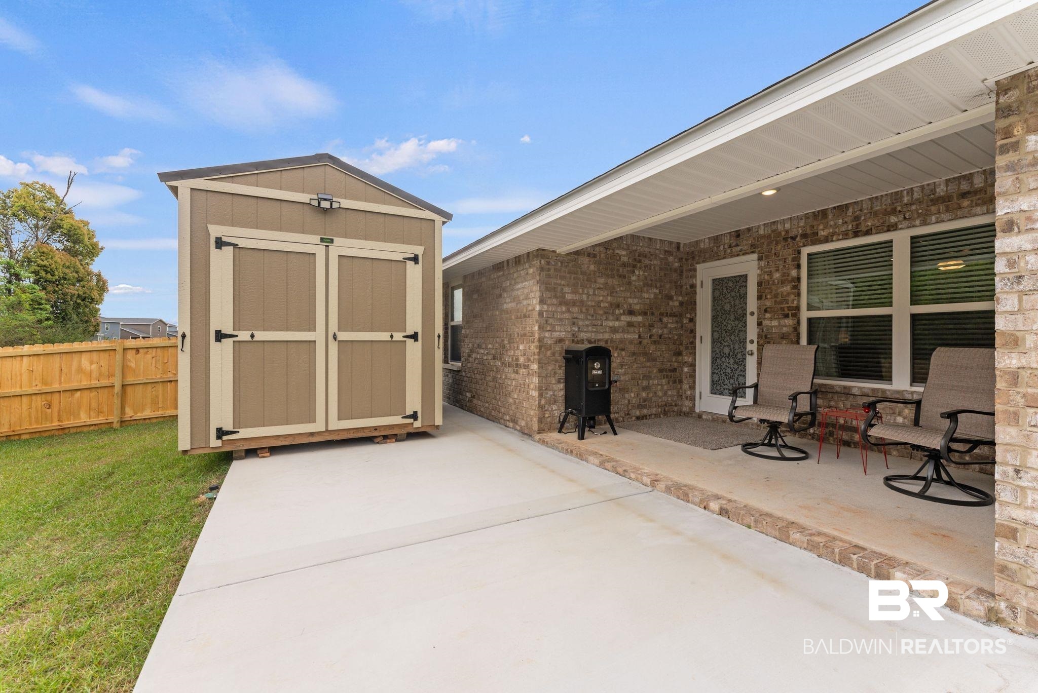 692 Mayflower Drive Foley, AL 36535 - Photo 33 of 40 View of patio / terrace with a storage shed