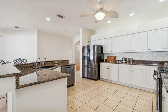 a kitchen with stainless steel appliances granite countertop a sink and cabinets