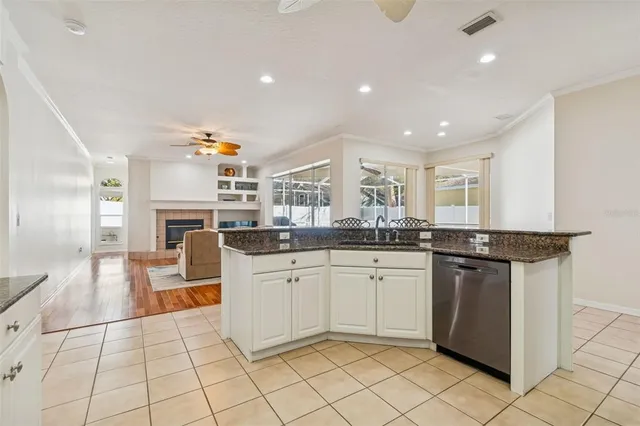 a kitchen with stainless steel appliances granite countertop a sink refrigerator and microwave
