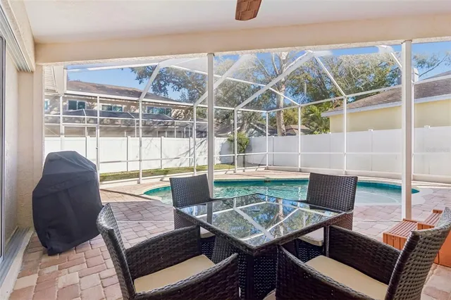 a view of a workspace with furniture and a large window