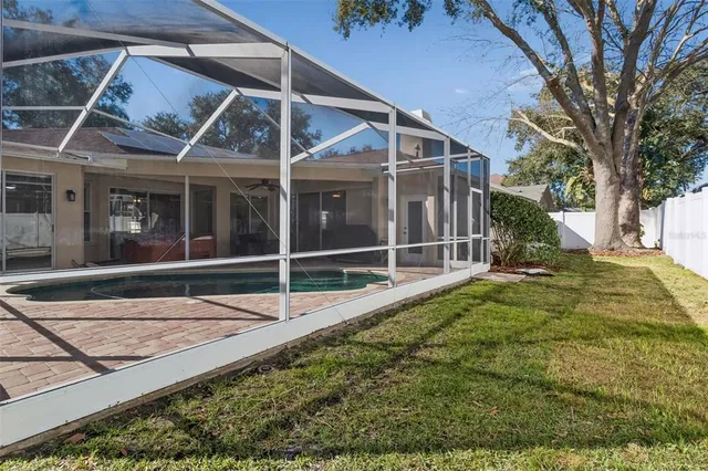 an aerial view of a house with a yard