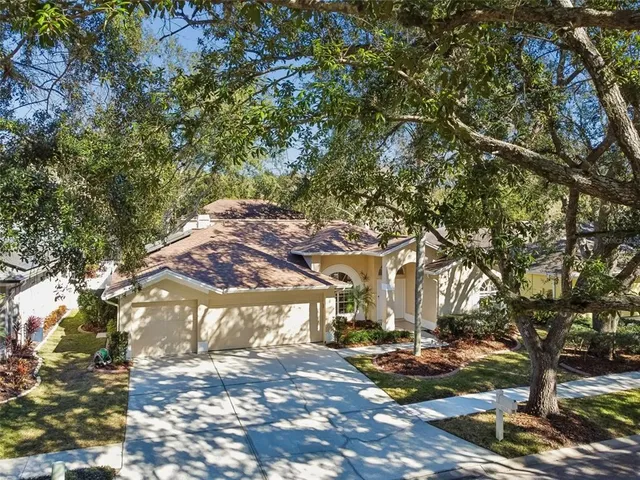 an aerial view of a house with outdoor space and lake view