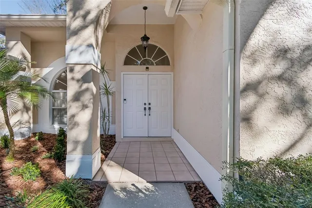 a view of a hallway with entryway and front door