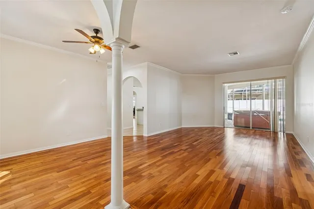 wooden floor in an empty room with a window