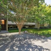 a view of a house with a tree in the background