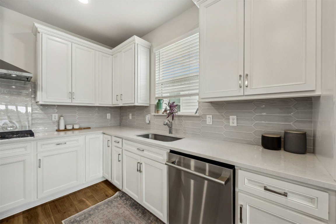 368 Muhly Grass Street Yulee, FL 32097 - Photo 13 of 60 a kitchen with white cabinets a sink and dishwasher