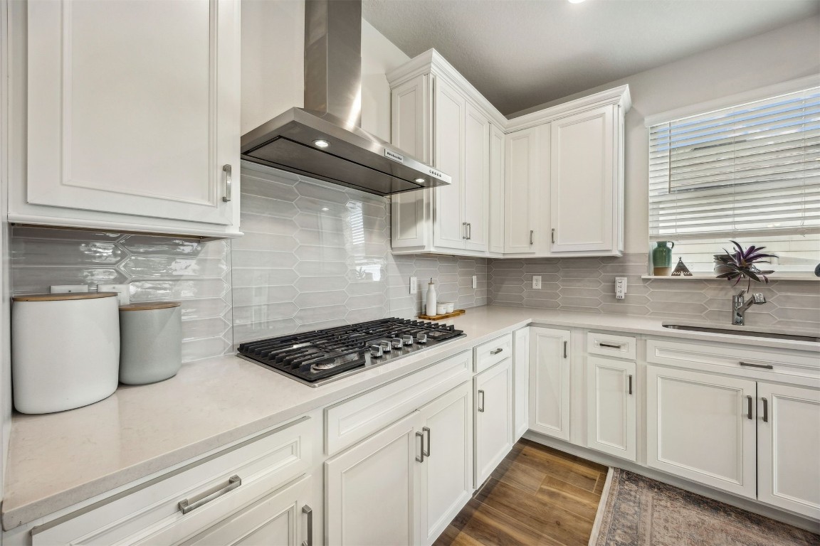 368 Muhly Grass Street Yulee, FL 32097 - Photo 15 of 60 a kitchen with granite countertop white cabinets white stainless steel appliances and sink