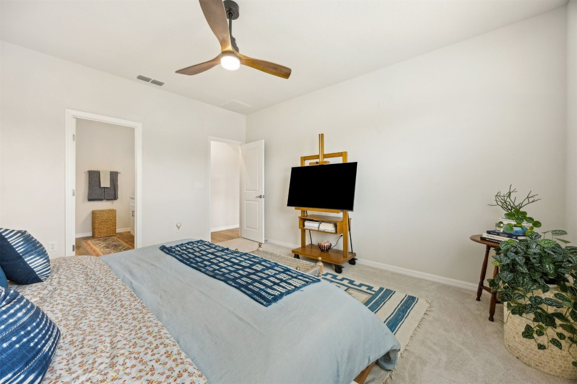 368 Muhly Grass Street Yulee, FL 32097 - Photo 21 of 60 a bedroom with a bed and a potted plant