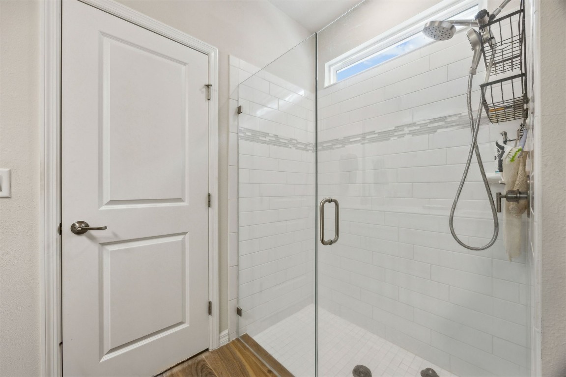 368 Muhly Grass Street Yulee, FL 32097 - Photo 23 of 60 a bathroom with a glass shower door